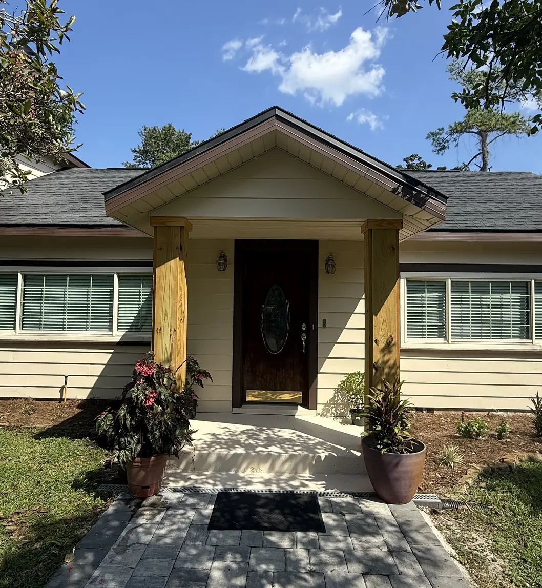 Single-story home with a freshly painted cream exterior and columned entry, Florida