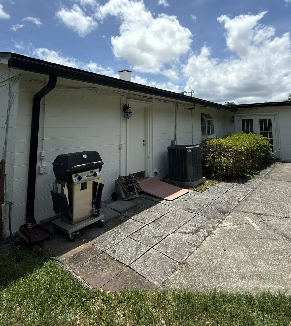 Freshly painted carport and side elevation of a single-story home, Florida